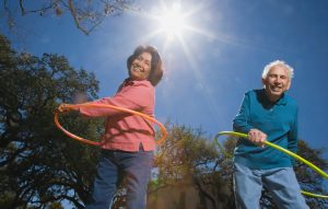 Low angle view of senior couple with hula hoops